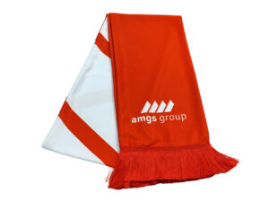 Dual-colour promotional scarf from AMGS Group with a bold logo and dense tassels, shown folded.
