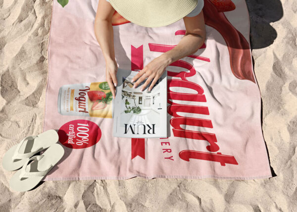 Microfiber Towel with Custom Print. Ideal for events and beach. Pink towel onn the beach where girl has picnic. Buy in amgs group.